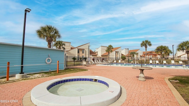 view of pool with a hot tub and a patio