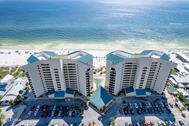 bird's eye view with a water view and a beach view