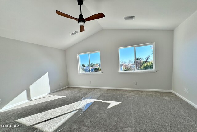 carpeted spare room with lofted ceiling and ceiling fan