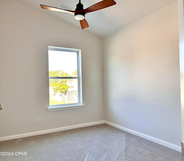 empty room featuring ceiling fan, carpet flooring, and vaulted ceiling