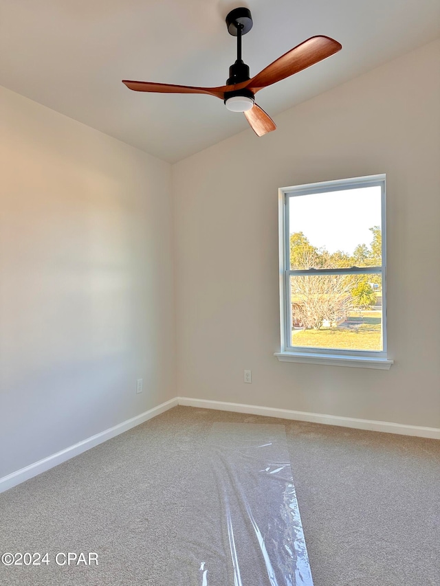 carpeted spare room with ceiling fan