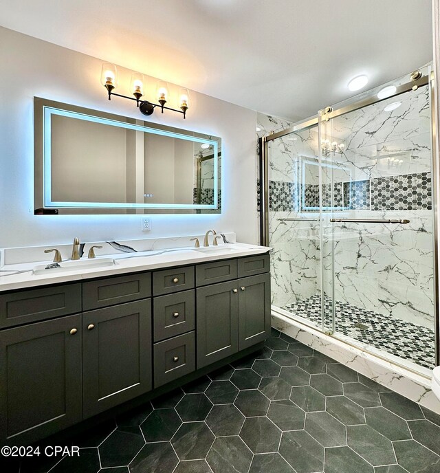 bathroom featuring tile patterned floors, a shower with door, and vanity