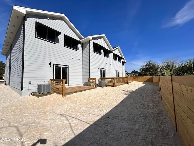 rear view of house featuring central AC