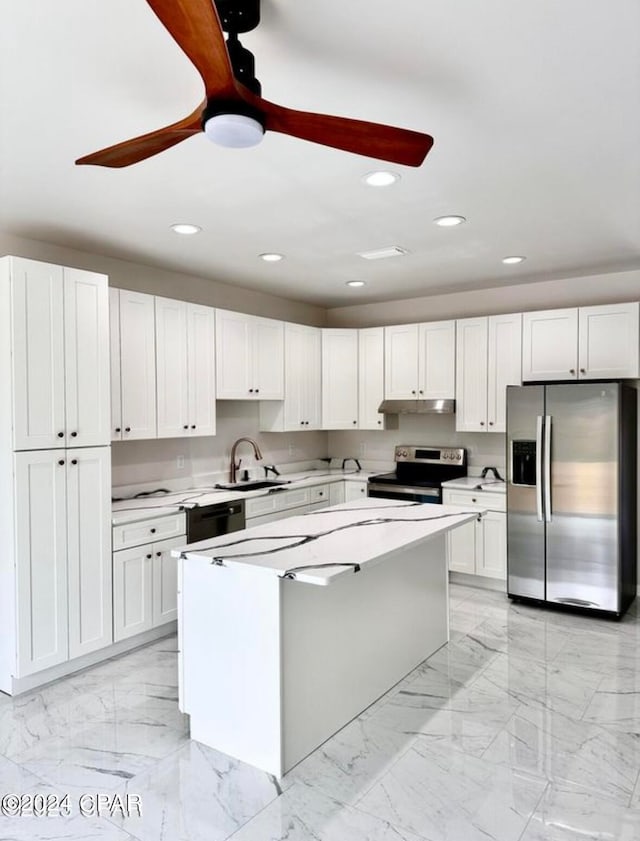 kitchen with a center island, sink, white cabinetry, appliances with stainless steel finishes, and ceiling fan