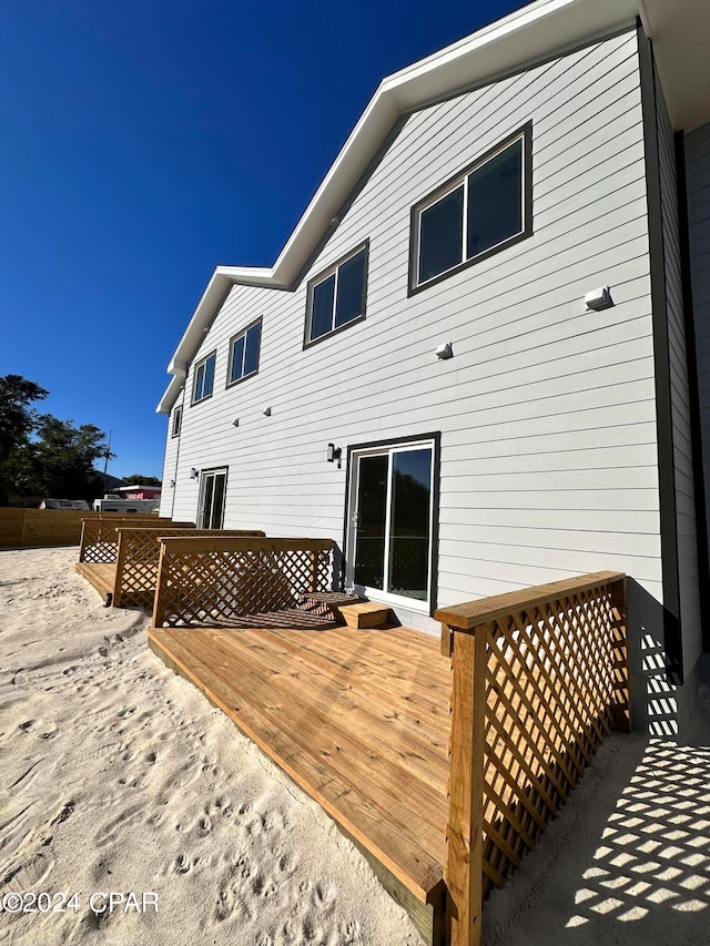 rear view of house featuring a deck