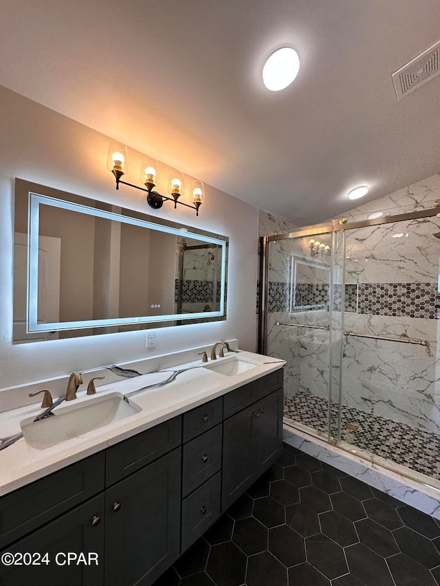 bathroom featuring vanity, tile patterned floors, and a shower with shower door