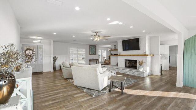 living room featuring ceiling fan and hardwood / wood-style flooring