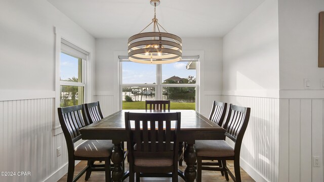 dining space featuring wood-type flooring and a chandelier