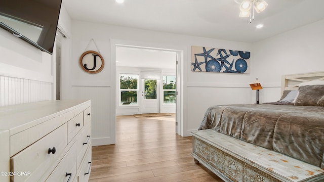 bedroom with light hardwood / wood-style floors and ceiling fan