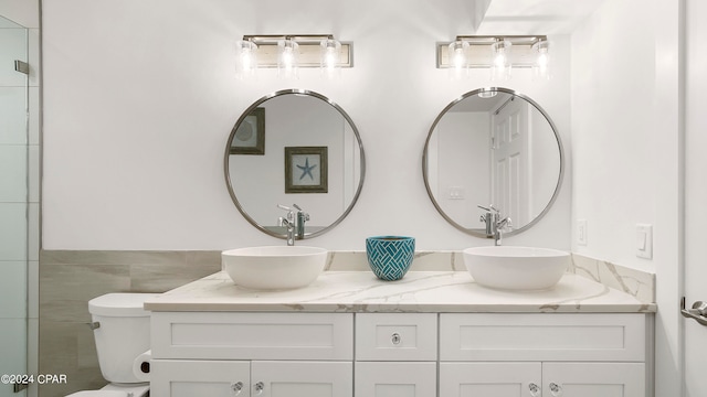 bathroom featuring tile walls, vanity, and toilet