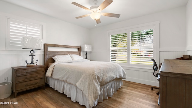 bedroom with ceiling fan and light hardwood / wood-style flooring