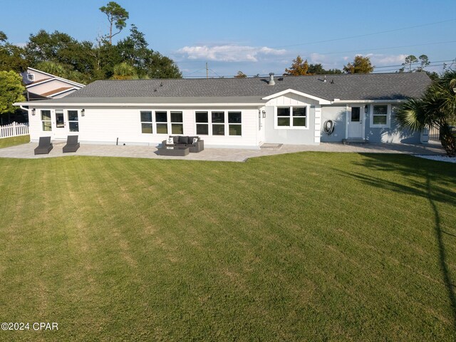 back of property with a patio and a lawn