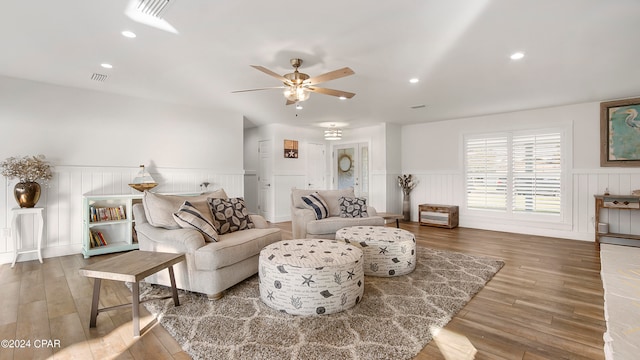 living room featuring ceiling fan and hardwood / wood-style floors