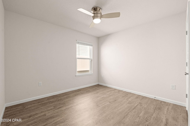 unfurnished room with ceiling fan and hardwood / wood-style flooring