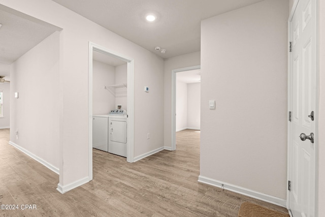 corridor featuring light hardwood / wood-style flooring and washer and dryer