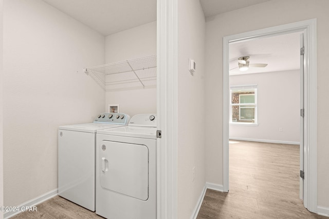 laundry area featuring light wood-type flooring, ceiling fan, and washing machine and dryer