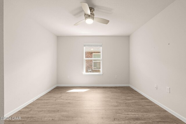 4925 Conner Ln, Panama City, FL 32404 - unfurnished bedroom featuring wood finished floors, baseboards, and a ceiling fan