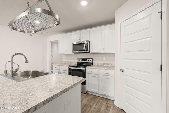 kitchen featuring white cabinetry, appliances with stainless steel finishes, and sink