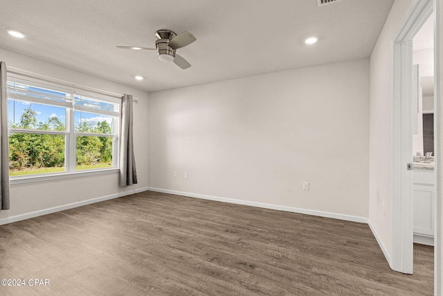 unfurnished room with ceiling fan and dark wood-type flooring