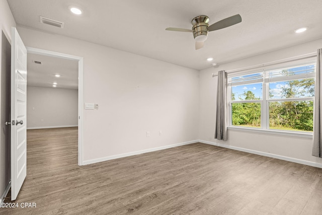 spare room with ceiling fan and wood-type flooring