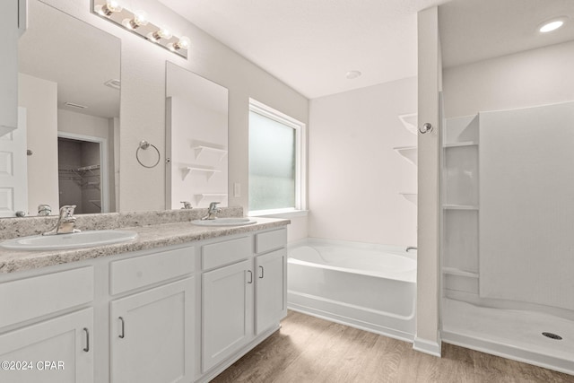 bathroom featuring vanity, separate shower and tub, and hardwood / wood-style flooring