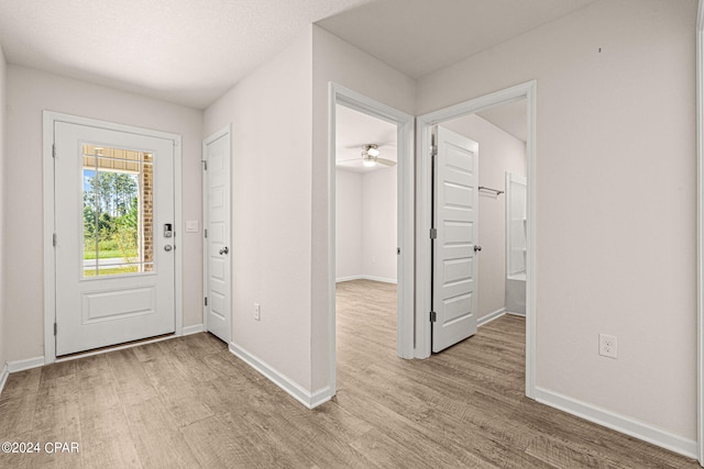 entryway with ceiling fan and light hardwood / wood-style flooring