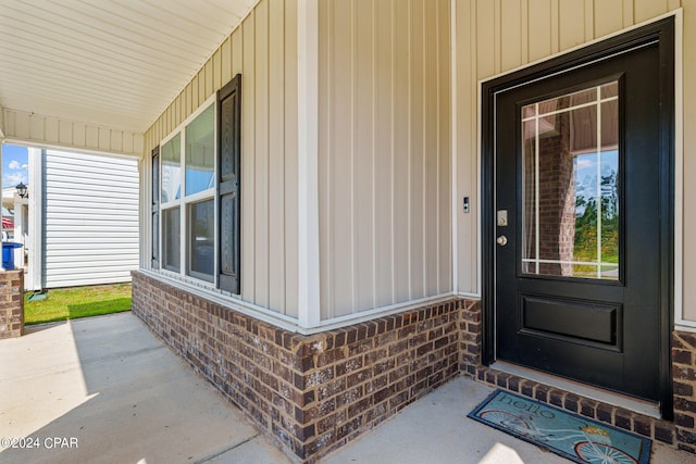 4925 Conner Ln, Panama City, FL 32404 - entrance to property featuring covered porch, board and batten siding, and brick siding