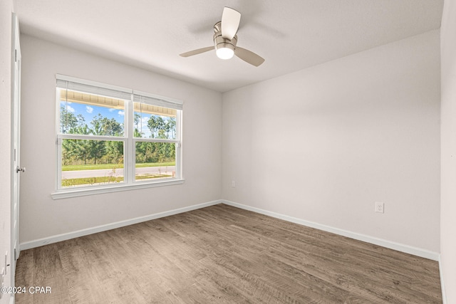 empty room with ceiling fan and hardwood / wood-style flooring