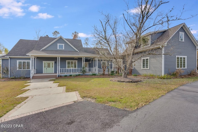 view of front of home with a porch and a front lawn