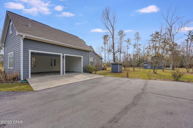 exterior space with a shed and a garage