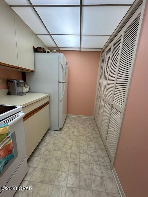 kitchen featuring white appliances and white cabinets