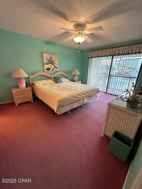 carpeted bedroom featuring ceiling fan, a textured ceiling, and access to exterior