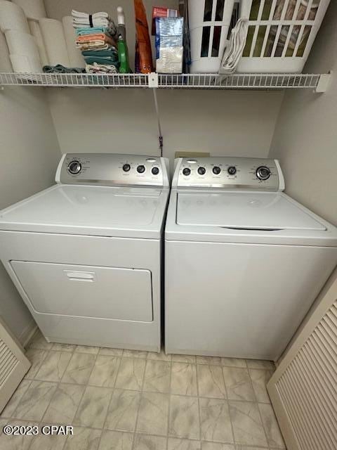 washroom with independent washer and dryer