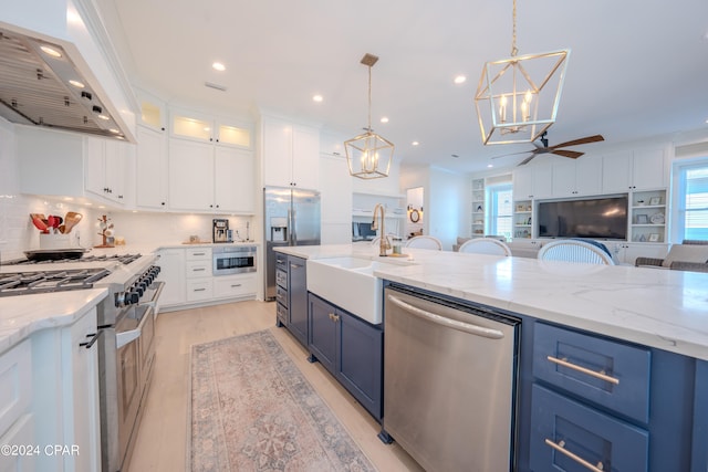 kitchen featuring ceiling fan with notable chandelier, blue cabinets, white cabinetry, and stainless steel appliances