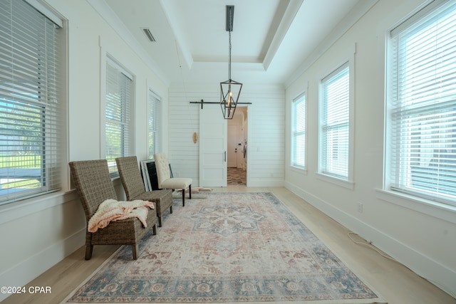 sitting room with light hardwood / wood-style flooring and wood walls