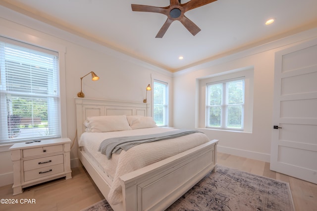 bedroom with light hardwood / wood-style flooring, multiple windows, and ceiling fan