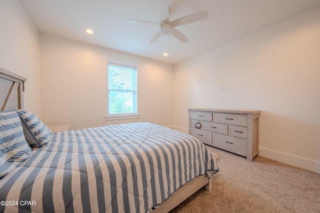 bedroom with ceiling fan and light colored carpet