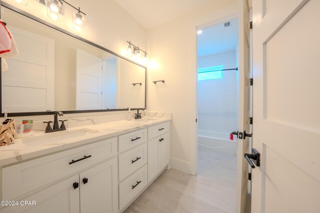 bathroom with vanity and bathtub / shower combination