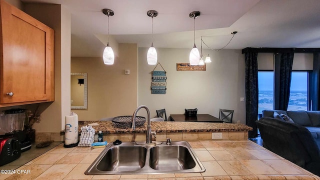 kitchen with pendant lighting, a notable chandelier, light tile patterned floors, and sink