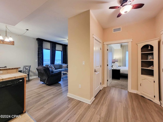 hallway featuring light hardwood / wood-style floors and an inviting chandelier