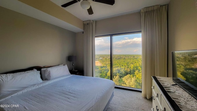 bedroom with ceiling fan and light colored carpet