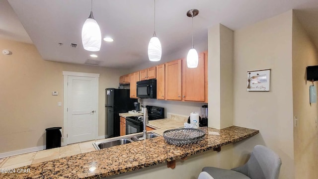 kitchen featuring kitchen peninsula, sink, black appliances, and decorative light fixtures