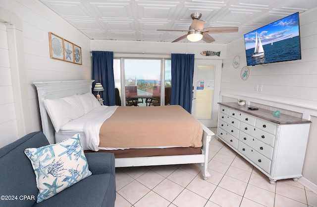 bedroom featuring access to outside, light tile patterned flooring, and ceiling fan