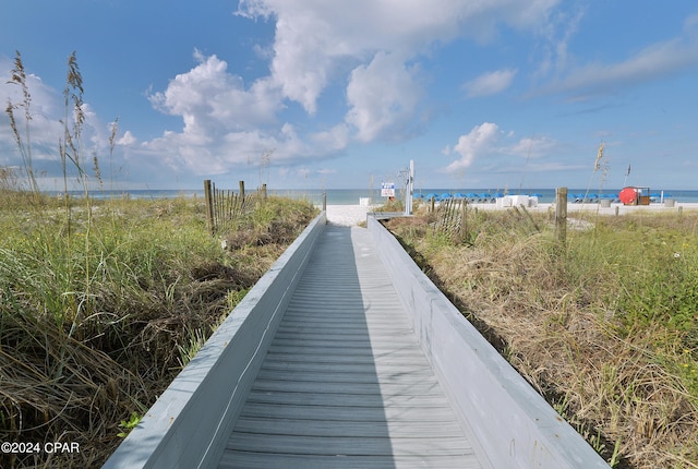 surrounding community with a view of the beach and a water view