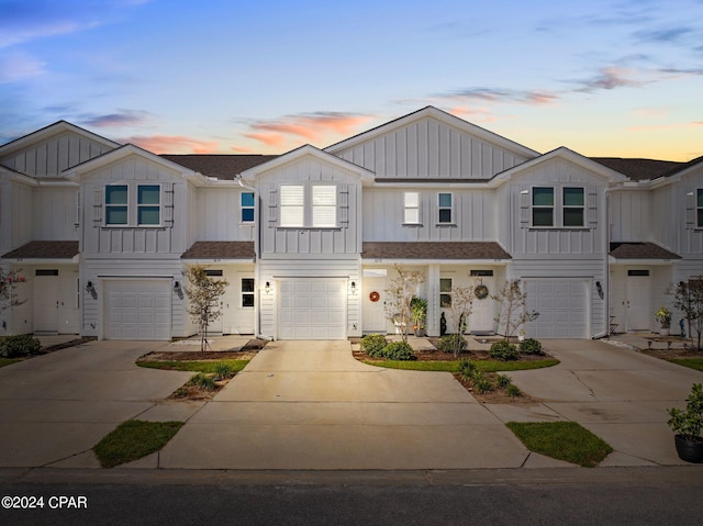 1632 Caleigh Ct, Lynn Haven, FL 32444 - view of property featuring an attached garage, board and batten siding, and driveway