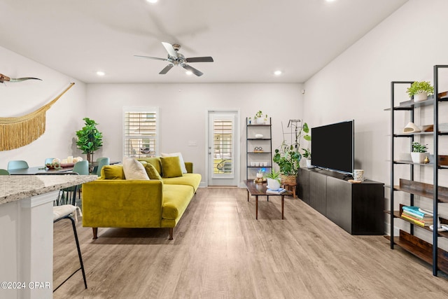 living room with ceiling fan and light hardwood / wood-style floors