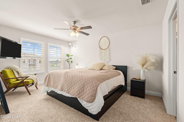 bedroom featuring light carpet and ceiling fan