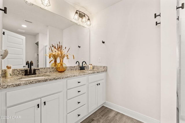 bathroom with vanity and hardwood / wood-style flooring