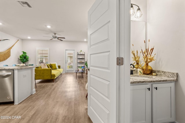 hall with light wood-type flooring and sink