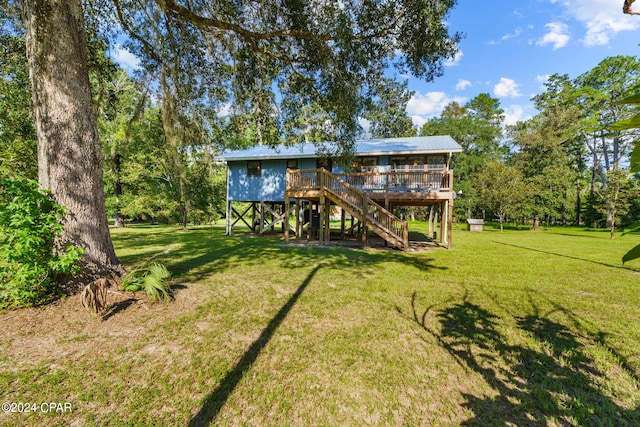 back of property with a lawn and a wooden deck